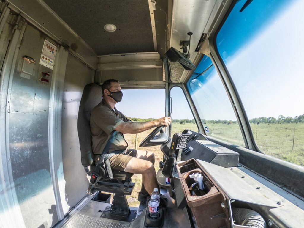 Delivery driver at the wheel of a courier van