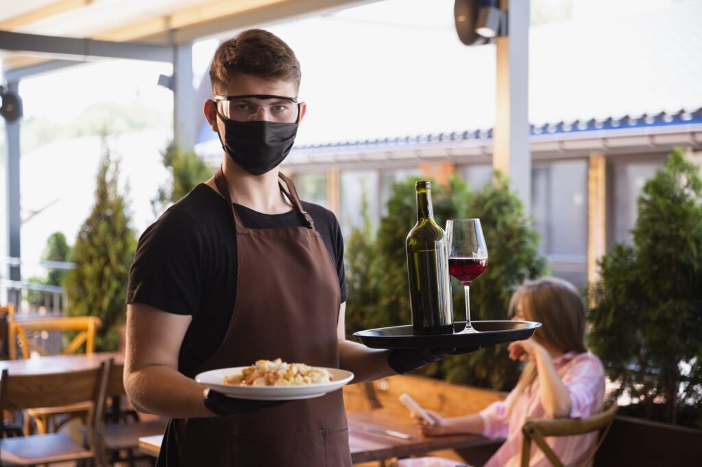 Hotel Waiter Jobs in Portugal 2026 | Salary, Requirements & Apply Now Restaurant waiter serving in a busy dining room